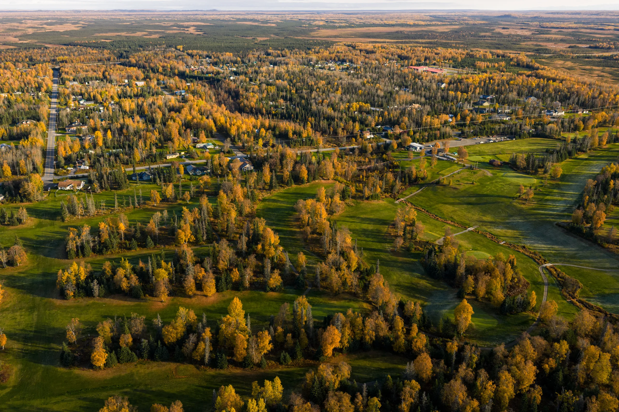 Kenai Golf Course driving range hitting area surrounded by spruce forest